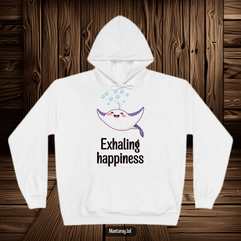 Funny Hoodie depicting a joyful manta ray blowing a stream of bubbles upwards towards the surface, bringing warmth and cheer.
